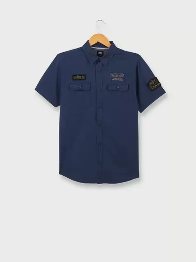 Chemise Manches Courtes Slim Unie Logo Brodé - Bleu offre à 22€ sur Devianne